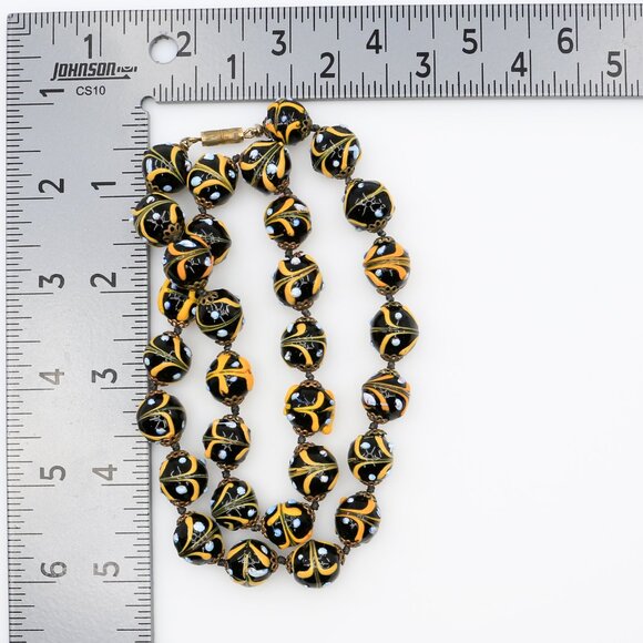 What color is this butterscotch glow-in-the-dark necklace? Vintage Handmade Lampwork Glass Beads Necklace UV‎ Glow Black and Yellow 1930s